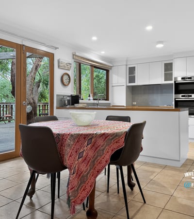 Spacious kitchen with modern appliances and direct access to an outdoor deck, perfect for entertaining.