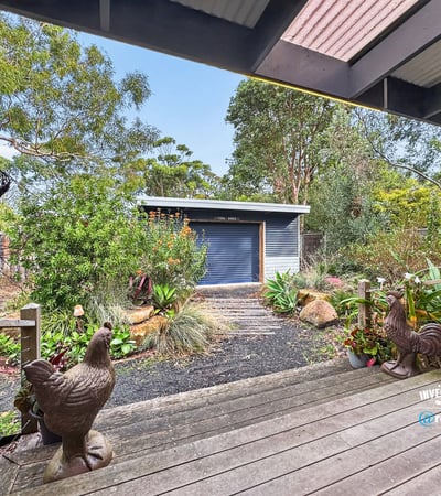 Nestled in lush surroundings, this property features a modern shed and vibrant landscaping perfect for outdoor enthusiasts.