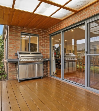 Enjoy outdoor entertaining on this spacious deck, featuring dual BBQs and easy access to the interior.