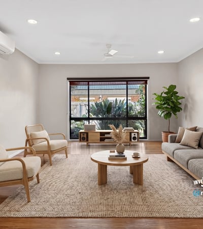 Bright living area features large windows, natural light, and modern furnishings, ideal for relaxed gatherings.