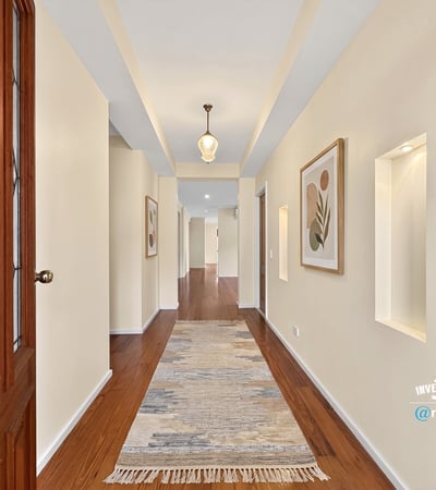 Bright and inviting hallway featuring natural light, modern finishes, and attractive art displays throughout.