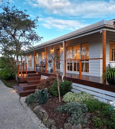 This inviting home features a spacious porch, landscaped gardens, and ample natural light throughout.