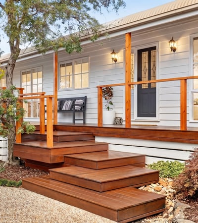 Experience modern living in this inviting home featuring a spacious deck, lush landscaping, and abundant natural light.