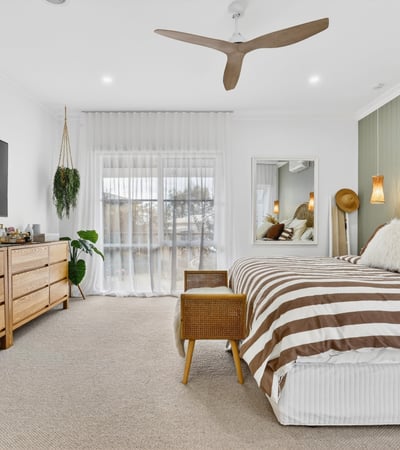 Bright and spacious bedroom featuring natural wood accents, large windows, and modern amenities for comfort.