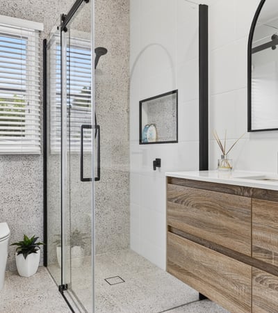 Modern bathroom featuring sleek lines, a spacious shower, and ample natural light for a refreshing ambiance.