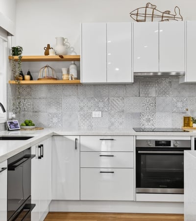 Modern kitchen featuring sleek cabinetry, advanced appliances, and eye-catching tile backsplash for a contemporary culinary experience.