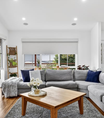 Spacious living area features large windows, offering abundant natural light and a cozy atmosphere.