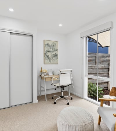 Bright and functional office space featuring natural light, modern furnishings, and streamlined storage solutions for productivity.