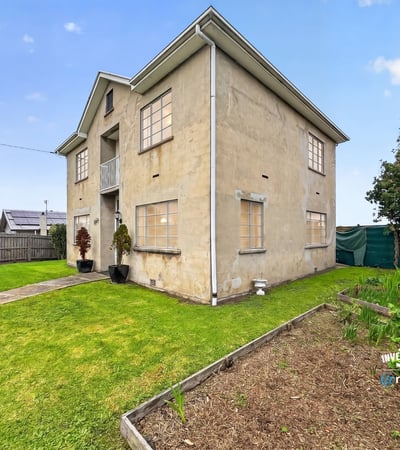 Spacious two-story home featuring a large yard and multiple windows for ample natural light.