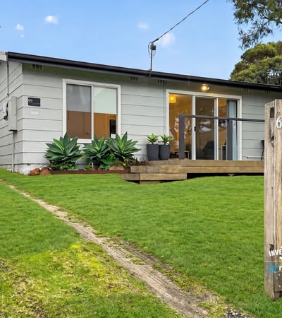 This cozy home features a spacious yard, modern design elements, and convenient access to local amenities.