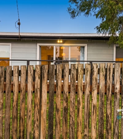 Cozy home with a welcoming front porch, perfect for enjoying outdoor moments in a friendly neighborhood.
