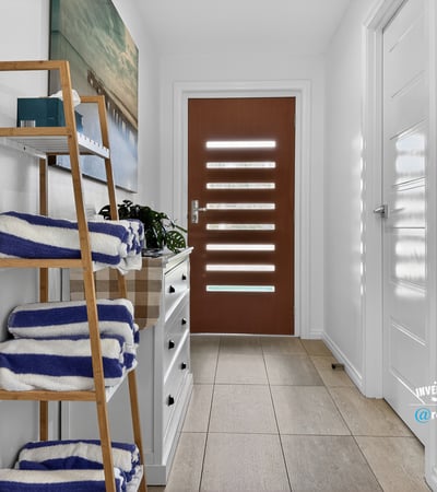 Bright and welcoming entryway featuring modern decor and practical storage solutions for your convenience.