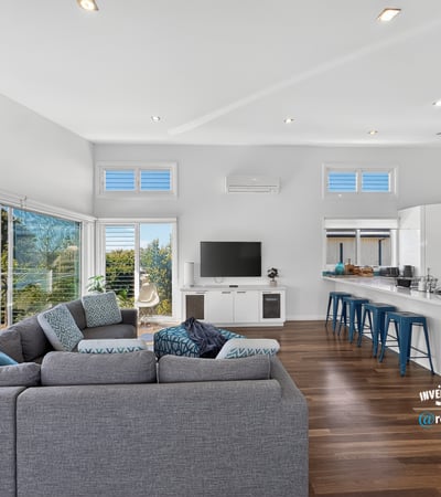 Bright, open-concept living space featuring modern design, large windows, and a seamless flow to outdoor views.