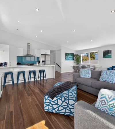 Modern open-concept living space with abundant natural light, featuring a sleek kitchen and inviting lounge area.