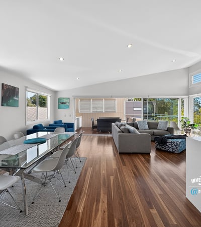Spacious open-plan living area with abundant natural light, modern furnishings, and picturesque views.