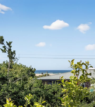 Enjoy stunning coastline views from this elevated property, surrounded by lush greenery and peaceful ambiance.