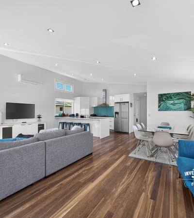 Modern open-concept living space with natural light, sleek design, and inviting atmosphere for family gatherings.