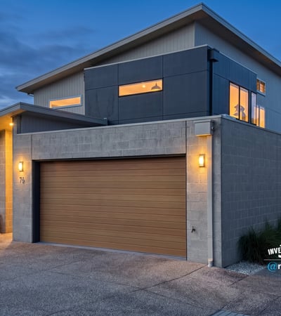 Modern two-story home featuring large windows, contemporary design, and convenient garage access in a vibrant neighborhood.