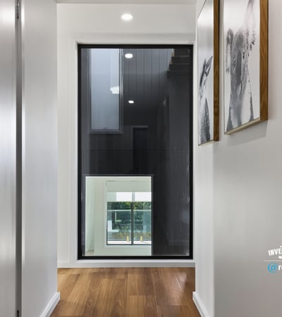 Contemporary hallway featuring sleek design and large windows, creating a bright and welcoming entryway.