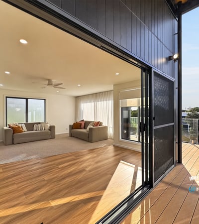 Bright, open living area seamlessly connects to an inviting outdoor deck, perfect for entertaining and relaxation.
