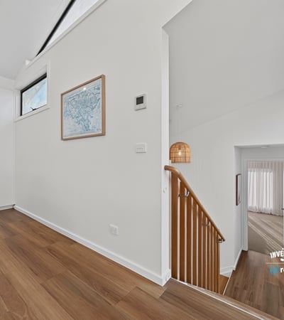 Bright and open foyer with modern design, leading to spacious living areas and stylish staircase.