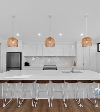 Bright and airy kitchen featuring modern finishes, ample counter space, and inviting seating for gatherings.