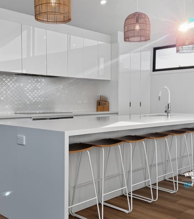Bright, modern kitchen featuring sleek cabinetry, a spacious island, and inviting seating for social gatherings.
