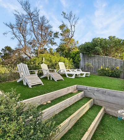 Discover a peaceful outdoor retreat featuring landscaped steps and ample seating for relaxation and enjoyment.