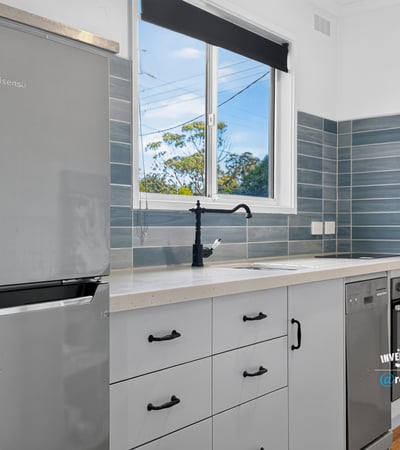 Modern kitchen featuring sleek appliances, ample storage, and natural light, perfect for culinary enthusiasts.