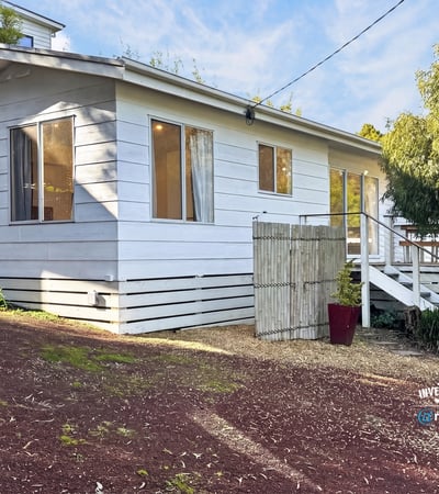 This inviting home features a spacious layout with large windows and a private outdoor area.