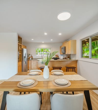 Bright and inviting kitchen with modern appliances, a spacious dining area, and lush garden views.