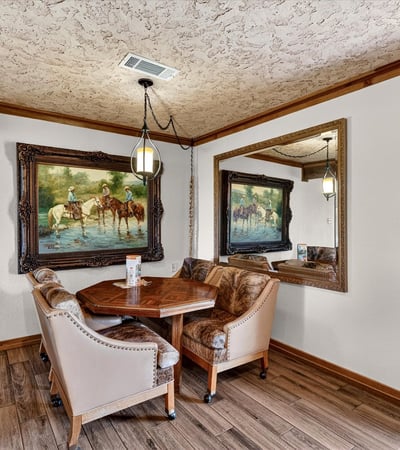 Cozy dining nook features natural light, unique artwork, and a welcoming atmosphere for intimate gatherings.