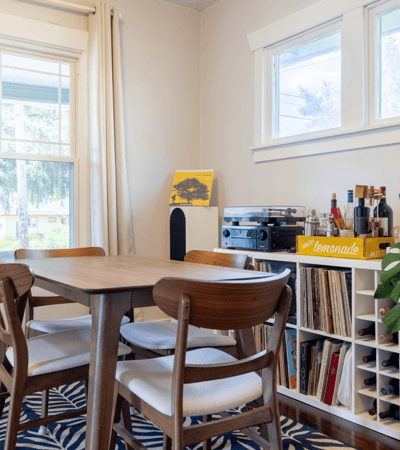 Bright dining area featuring a wooden table, modern decor, and ample natural light, perfect for gatherings.