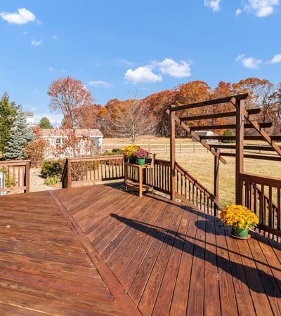 A paver walkway off the deck leads to the spacious fenced-in yard, paver patio, garden shed, and gate to the driveway.