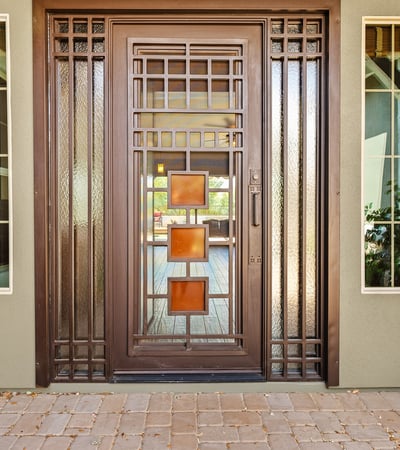 This custom iron front door makes a bold architectural statement while enhancing security and natural light, setting the tone for the craftsmanship found throughout the home.