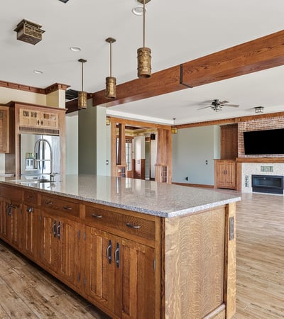 Wide open kitchen and living area showcasing wood beams, cohesive finishes, and generous square footage. A hallmark of this Phoenix home s thoughtful open concept design.