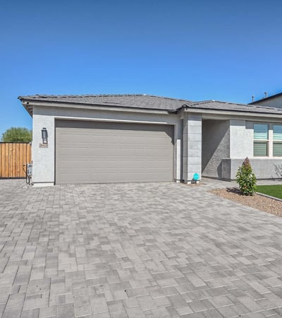 This eye-catching Peoria home showcases a sleek exterior design with a wide paver driveway, manicured synthetic turf, and a welcoming front entry. The spacious two-car garage and side RV gate offer added convenience and storage flexibility. Designed with curb appeal and low-maintenance living in mind, the home blends modern elegance with functional upgrades that enhance everyday living and energy efficiency.