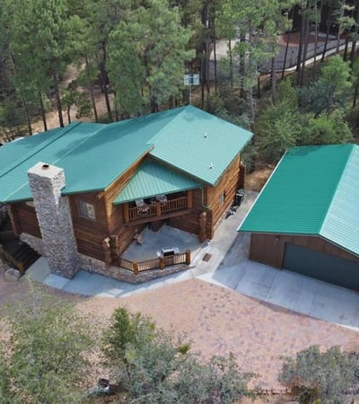 Aerial view highlighting the home s secluded setting, quality log construction, and detached garage. Surrounded by pines, this Prescott property offers privacy and a true mountain lifestyle.