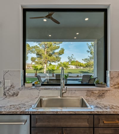 Scenic backyard and pool views from the kitchen sink enhance daily living in this beautifully updated Scottsdale home.