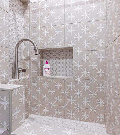 Stylish tiled dog wash with sink and storage makes pet care practical, adding to the Scottsdale home s modern upgrades.
