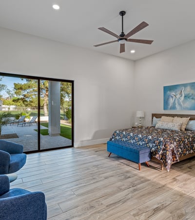 Elegant main bedroom with sliding doors to patio and pool access combines indoor comfort with outdoor Scottsdale living.