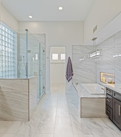 Remodeled primary bath with soaking tub, dual vanities, and spa-inspired shower offers a luxurious retreat.