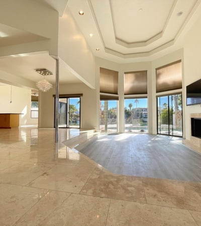 Grand open living area with marble floors, soaring ceilings, and wide windows that fill the space with Scottsdale sunshine.