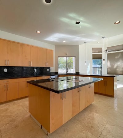 Spacious chef s kitchen featuring granite countertops, maple cabinetry, and stainless steel appliances a perfect blend of luxury and functionality.