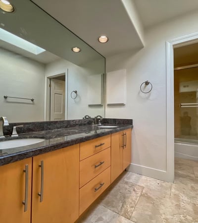 Refined guest bath with dual-sink vanity, granite surfaces, and soft neutral tones. Perfectly balanced between style and function.
