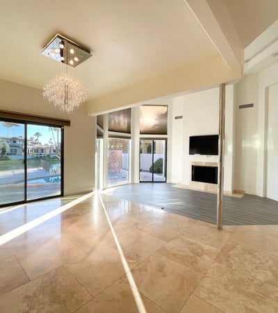 Sun-drenched living area featuring sliding doors to the patio and pool. Perfect for gatherings and relaxed lakefront living.