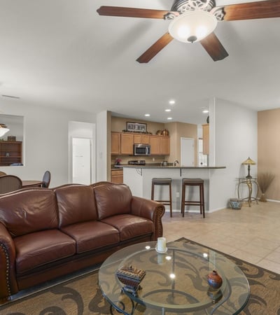 The open great room showcases tile flooring, neutral colors, and recessed lighting. Ideal for entertaining, it seamlessly connects to dining and kitchen spaces.