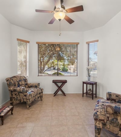 Relax in this cheerful breakfast nook surrounded by windows and natural light. A comfortable, airy space ideal for casual dining or reading.