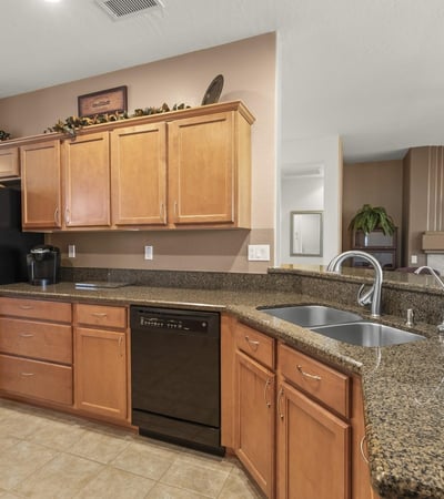 Enjoy a kitchen that blends warmth and practicality, offering expansive countertops, ample cabinets, and a seamless connection to the main living area.