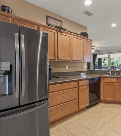 Designed for togetherness, this kitchen opens to the living room with modern finishes and a granite breakfast bar that invites casual dining.